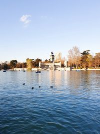 Scenic view of lake by building against clear sky