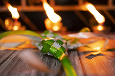 Close-up of burning candles on table