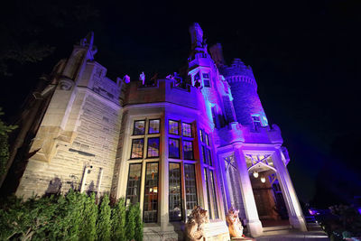 Low angle view of illuminated building at night