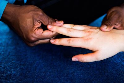 Close-up of hands touching baby
