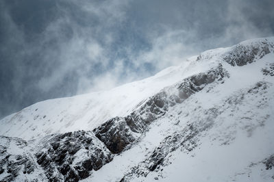 Scenic view of snow covered mountains against sky