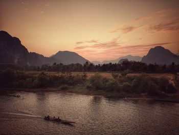 Scenic view of river against sky during sunset