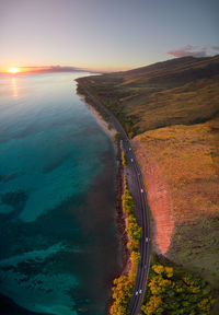 High angle view of road by sea against sky during sunset