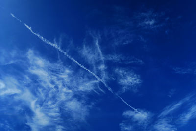 Low angle view of vapor trails in sky