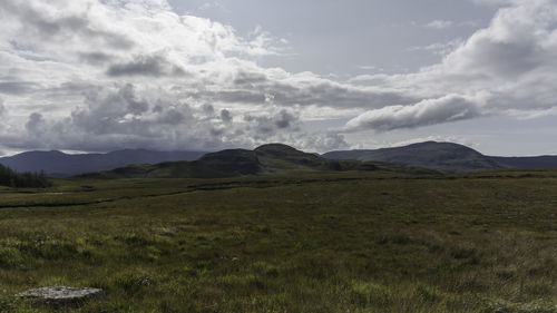 Scenic view of mountains against cloudy sky