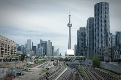 High angle view of railroad tracks against cn tower and buildings in city