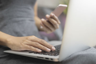 Midsection of woman using mobile phone