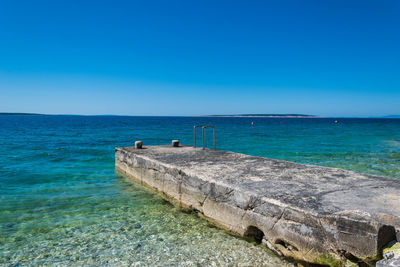 Scenic view of sea against clear blue sky