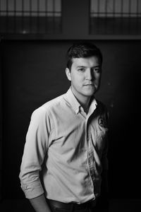 Young man standing against wall