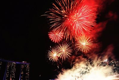 Low angle view of firework display at night