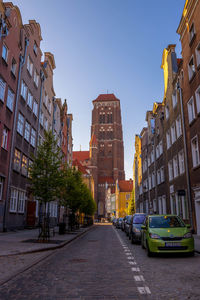 Street amidst buildings against sky in city