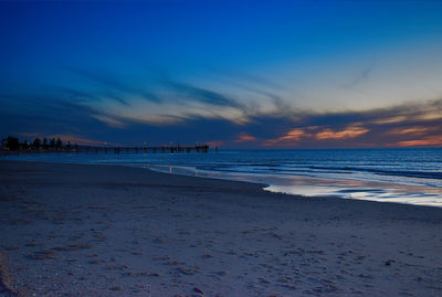 Scenic view of beach against sky during sunset