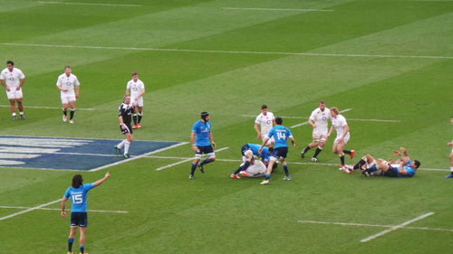 People playing soccer on grassy field