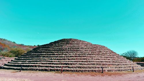 Close-up of archeological structure against clear blue sky