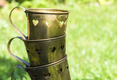 Close-up of drink in container on field