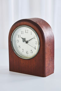 Close-up of clock on table