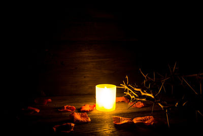 Lit candles on wooden table