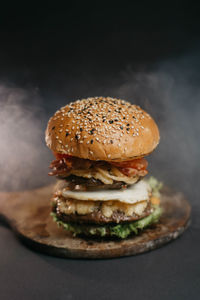 Close-up of burger against black background