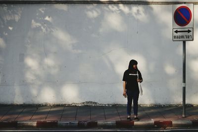 Rear view of man standing on road