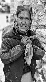 Portrait of woman with umbrella standing in winter