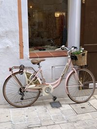 Bicycle leaning on wall of building