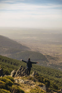 Man standing on mountain against sky