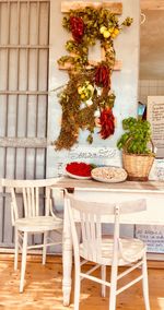 Potted plant on table against wall at home