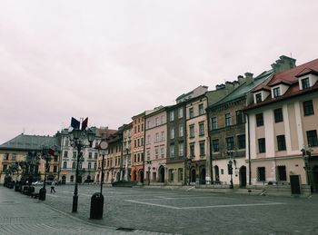 Street amidst buildings in city against sky