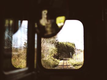 Railroad track seen through train window