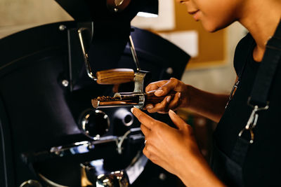 Midsection of woman working in cafe