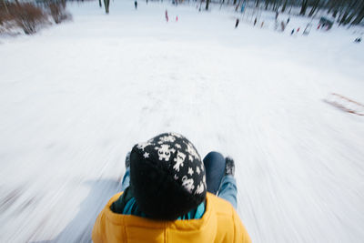 Rear view of person on snow covered land