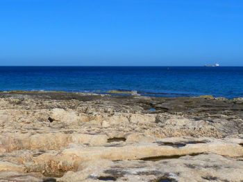 Scenic view of sea against clear blue sky