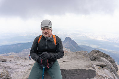 Portrait of man sitting on mountain