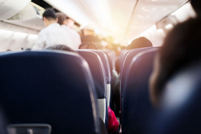 Rear view of people sitting in airplane