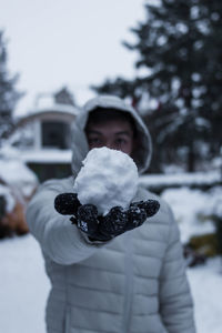 Portrait of person standing in snow