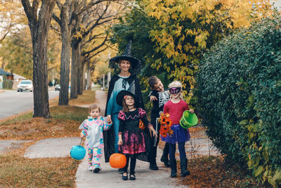 Trick or treat. mother with children going to trick or treat on halloween holiday. 