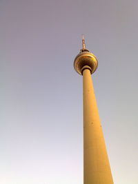 Low angle view of fernsehturm against clear sky during sunset