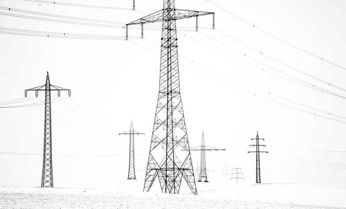 Low angle view of electricity pylon against sky