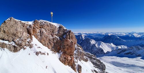 Scenic view of snowcapped mountains against clear blue sky