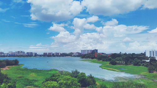 View of cityscape against cloudy sky