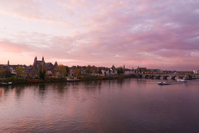 View of buildings against cloudy sky at sunset