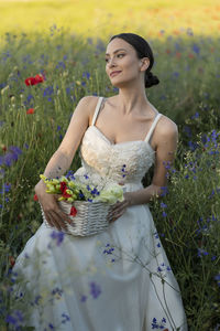 Young woman standing amidst plants