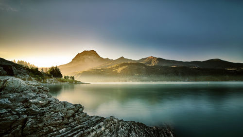 Scenic view of lake against sky during sunset