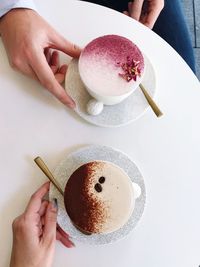 Midsection of woman holding coffee cup on table