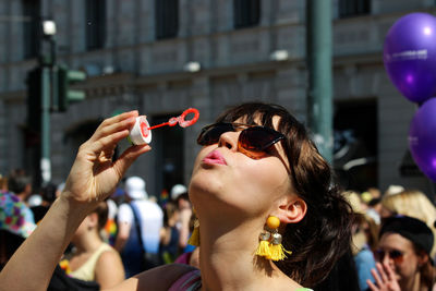 Portrait of woman with bubbles in city