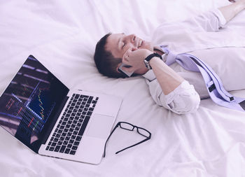 High angle view of mobile phone on bed