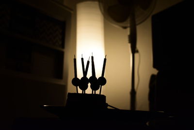 Close-up of illuminated candles in temple