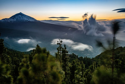 Panoramic view of volcanic mountain against sky during sunset
