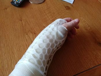 Low section of person on hardwood floor