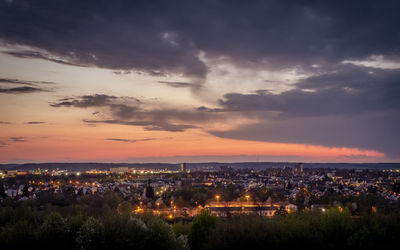 High angle view of illuminated buildings against sky at sunset